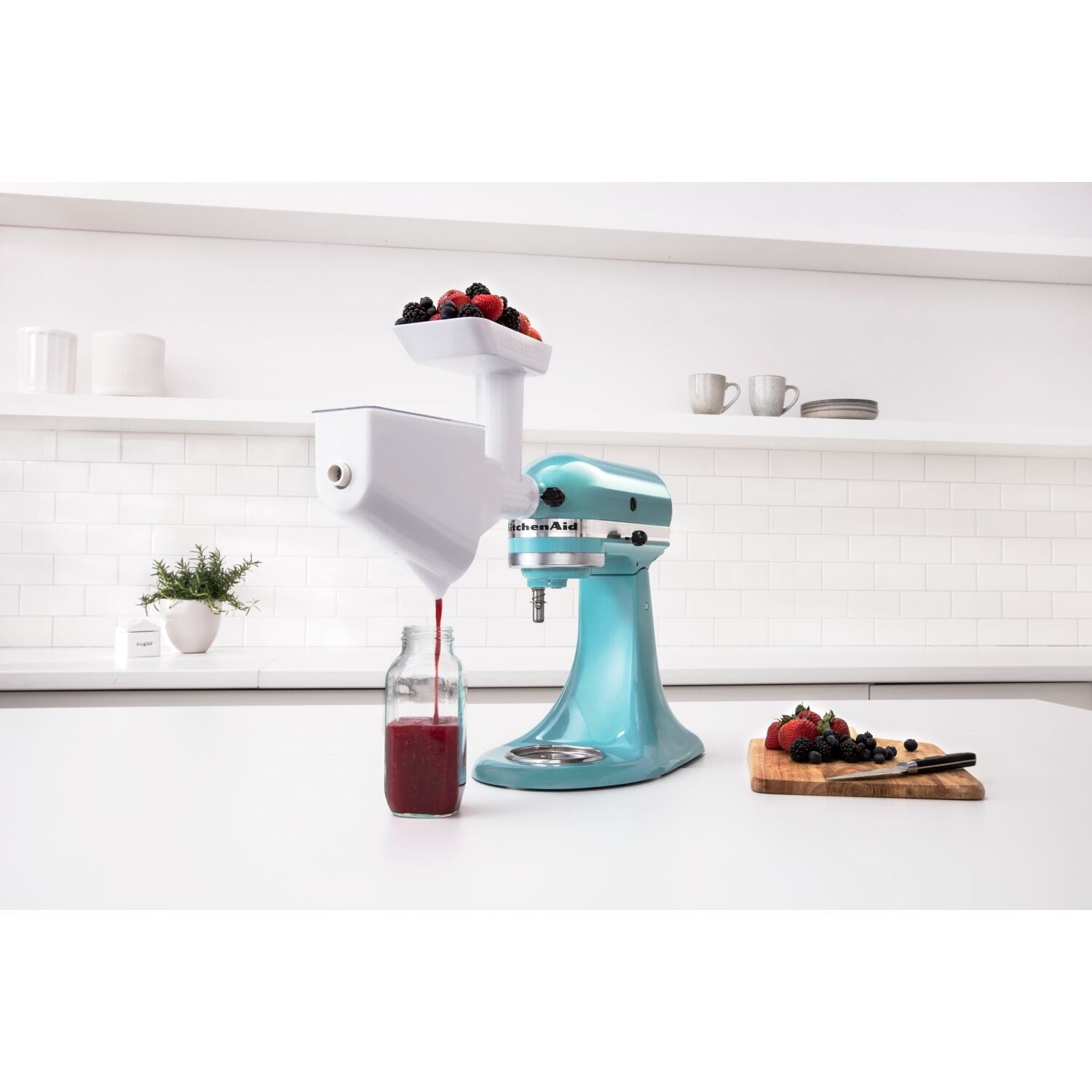 Blue aqua tilt-head stand mixer with dough hook accessory and stainless bowl, side view