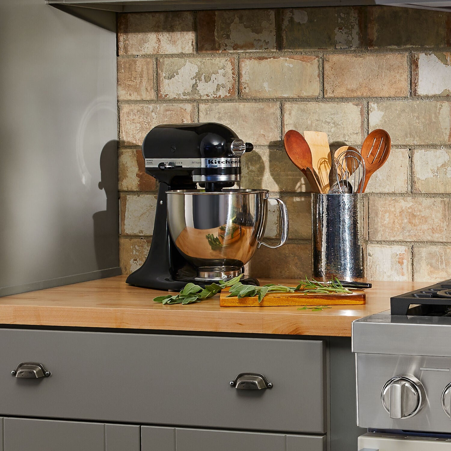 Onyx black tilt-head stand mixer with stainless bowl on countertop