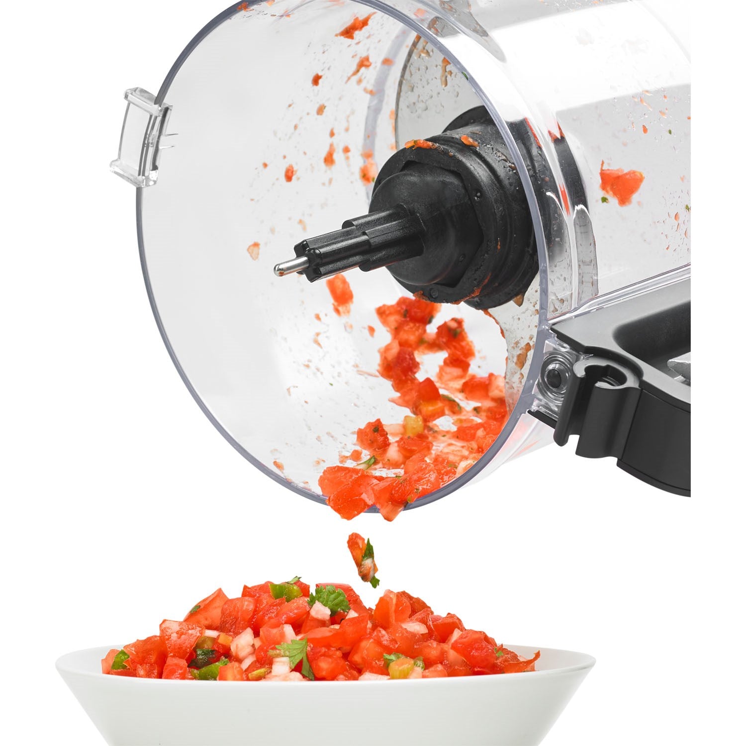 Food processor with slice-shred blade ejecting chopped vegetables from open bowl