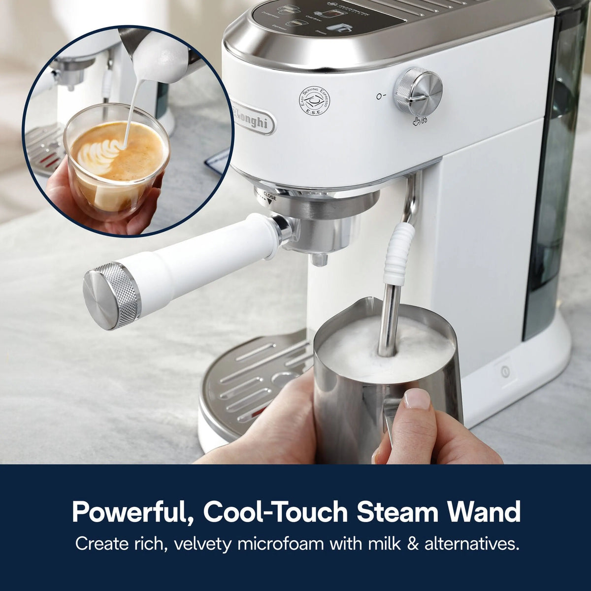Cool-touch steam wand frothing milk into a metal cup, espresso machine front view
