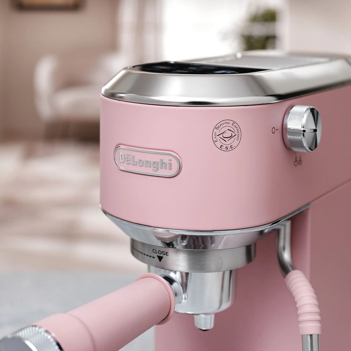 Pink espresso machine with stainless steam wand and round control knob