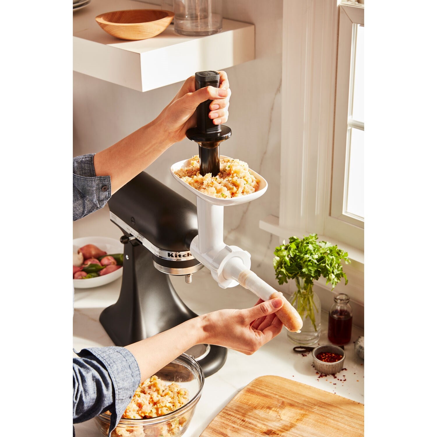 KitchenAid sausage stuffer kit attachment filling a bowl with ground meat
