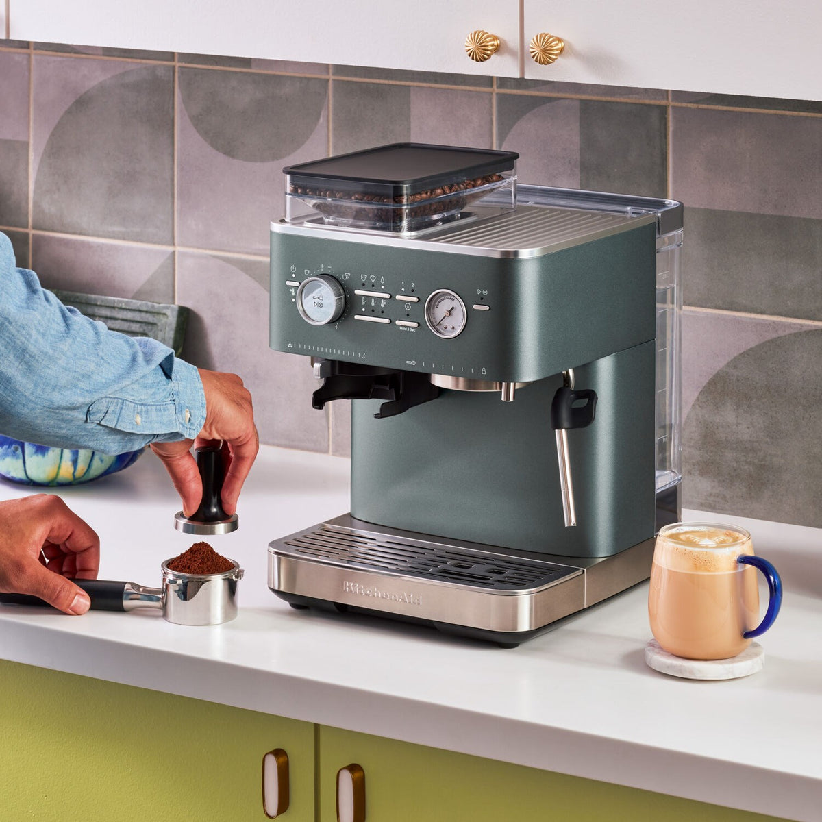 Juniper green espresso machine on countertop with cup and portafilter tools