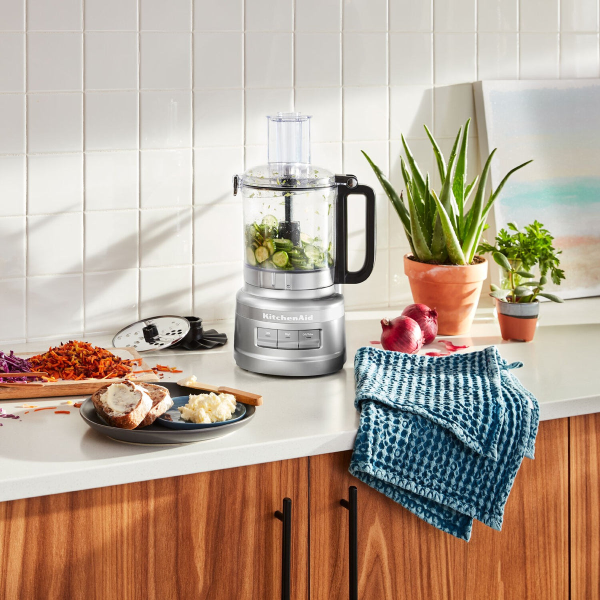 KitchenAid 7-cup food processor in Contour Silver with clear bowl, handle, and base controls