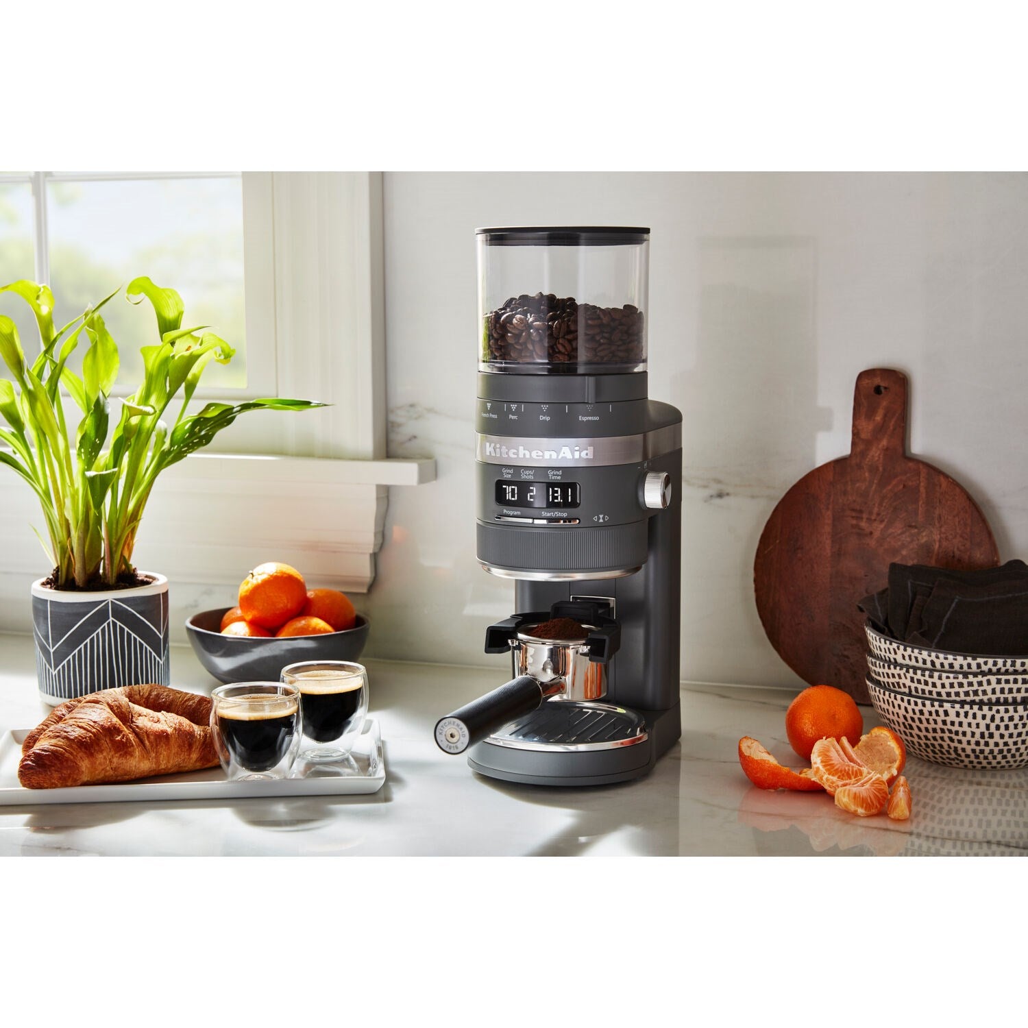 Charcoal grey burr coffee grinder with bean hopper on kitchen counter