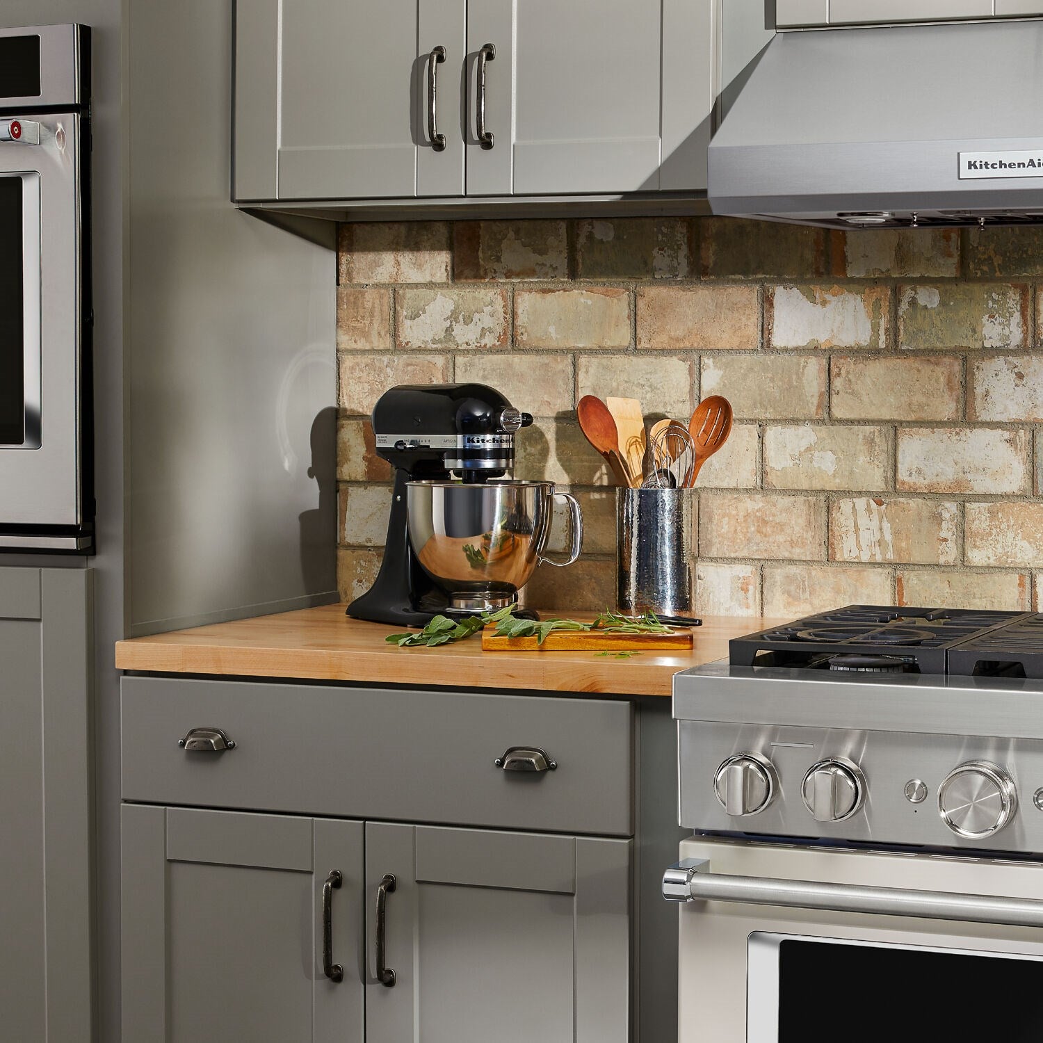 Onyx black tilt-head stand mixer with stainless bowl on kitchen counter