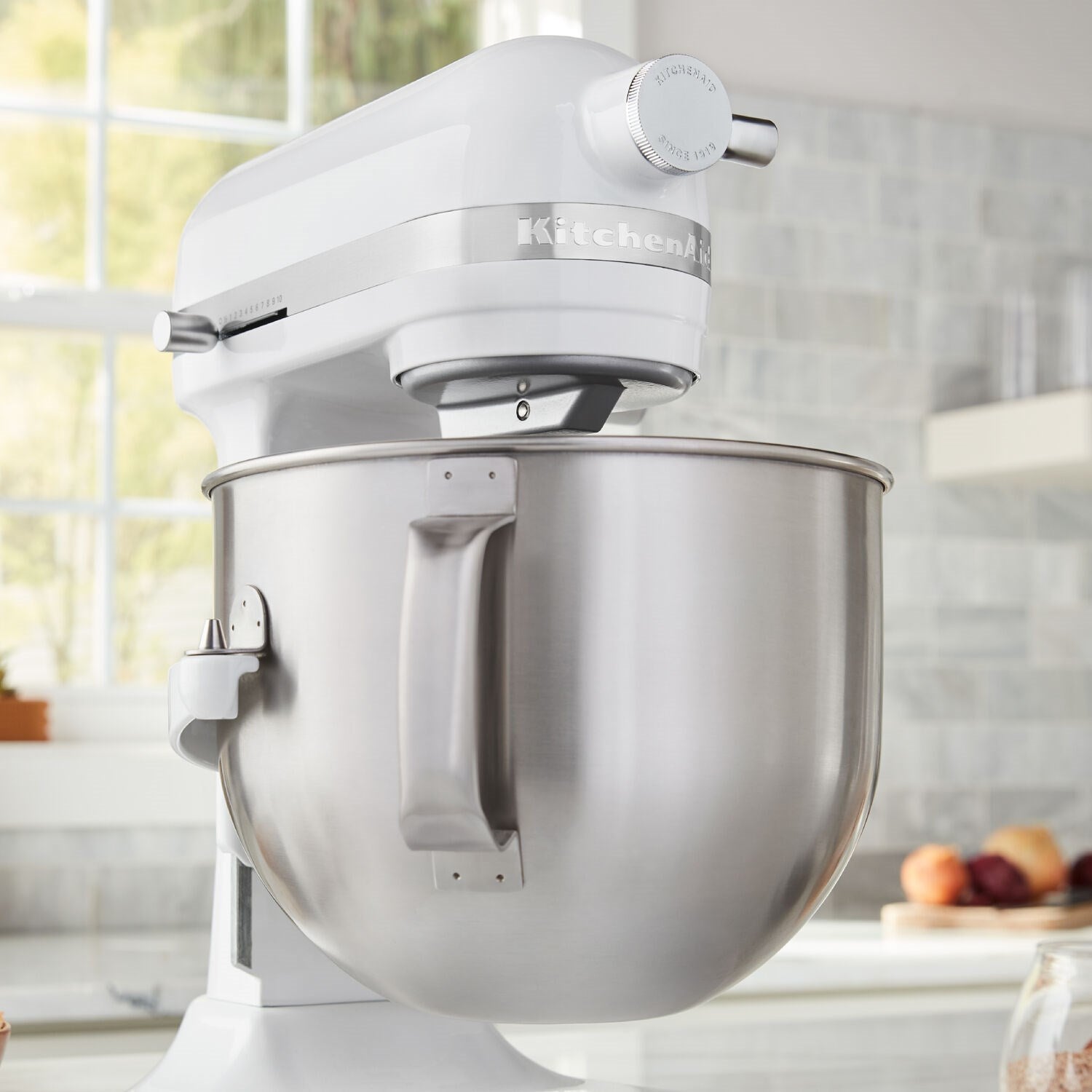 White KitchenAid stand mixer bowl and beater attachment with stainless mixing bowl