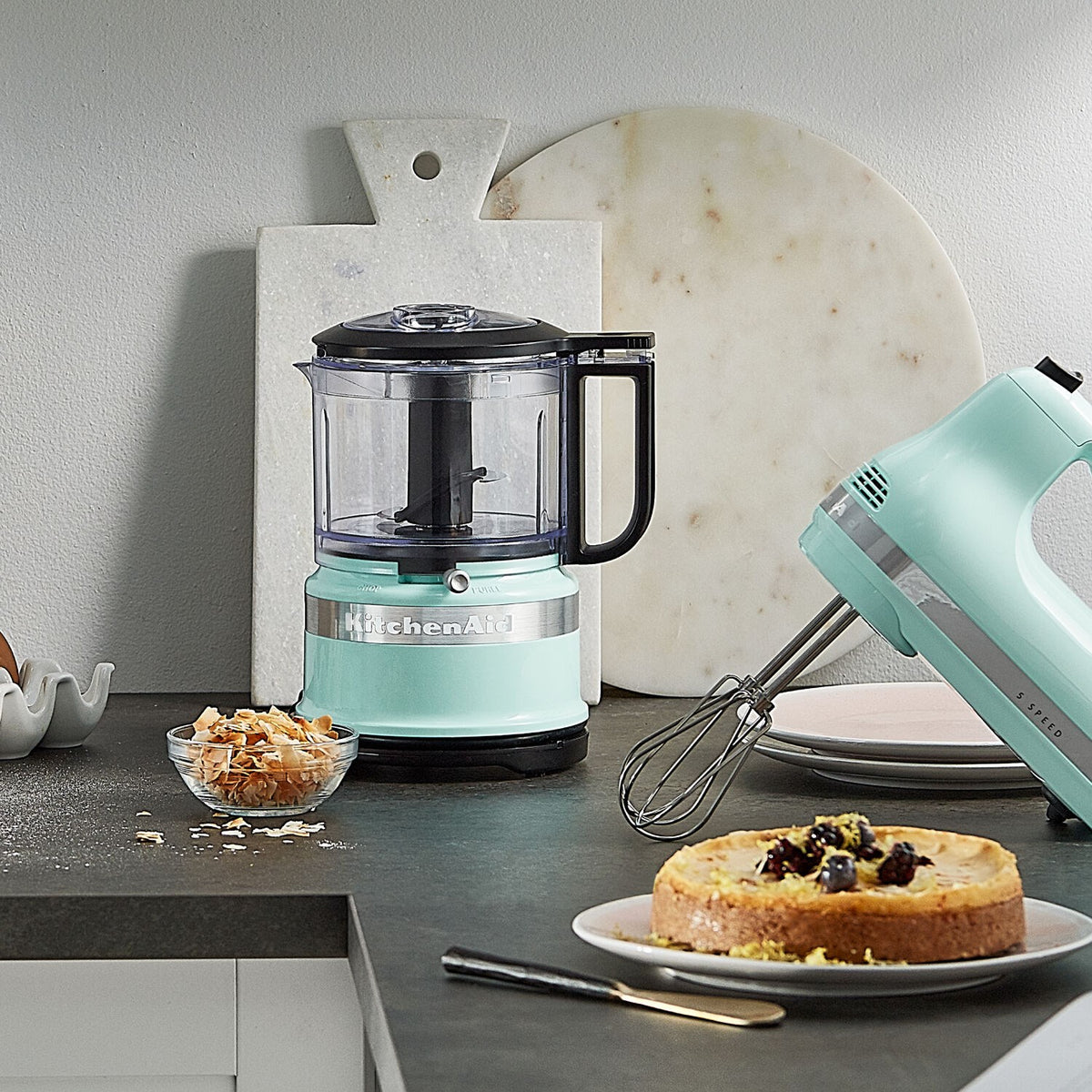 KitchenAid 3.5-cup food chopper on countertop with ice-blue base and clear mixing bowl