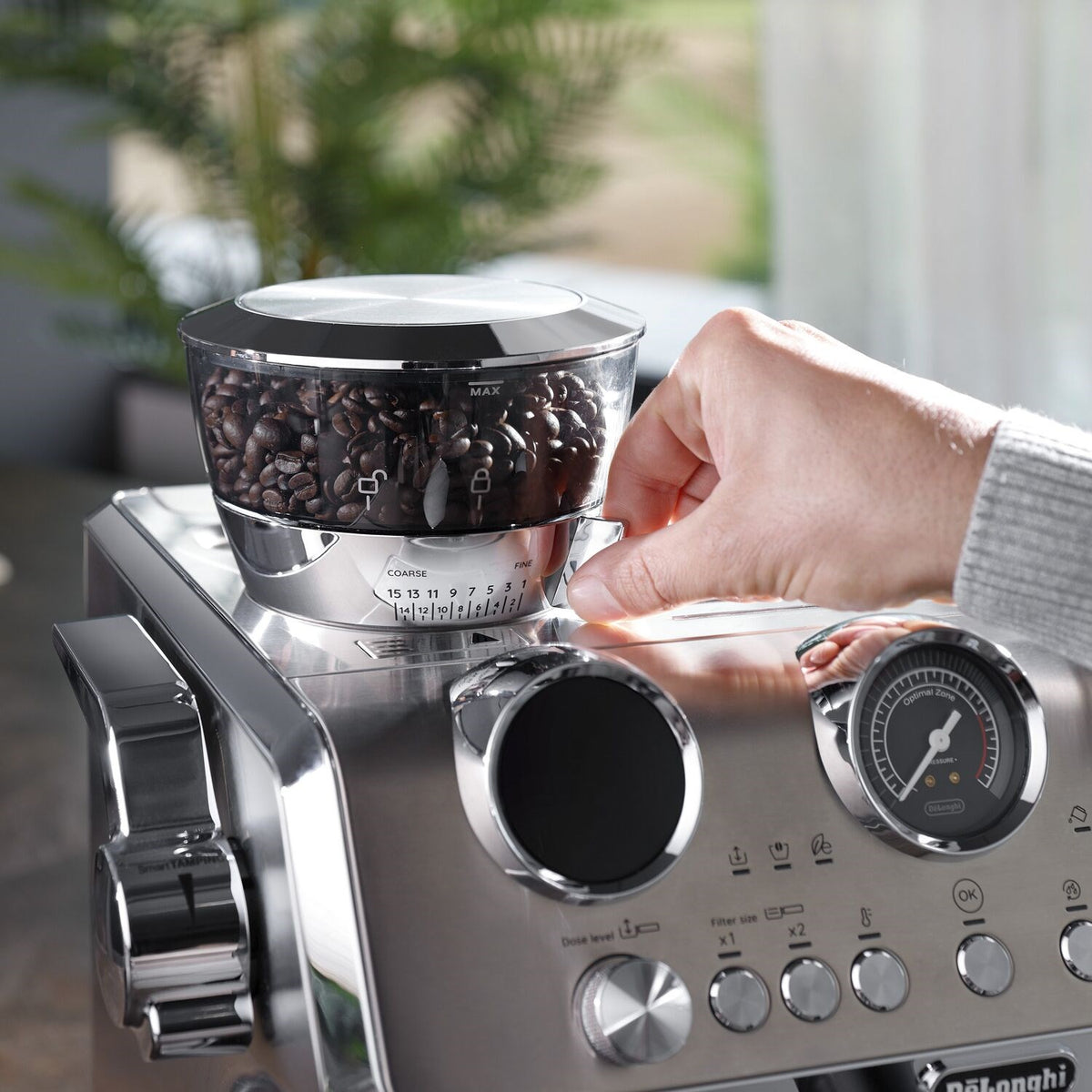 Stainless steel De'Longhi espresso machine with bean hopper and control dial