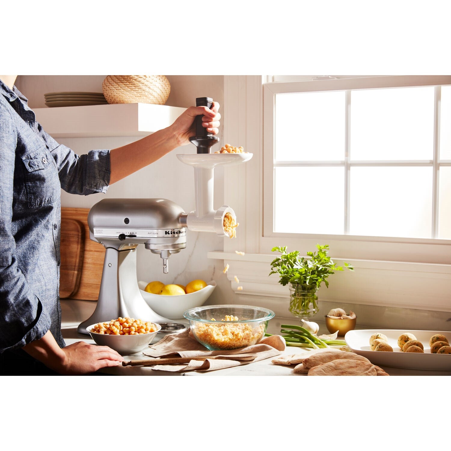 Food grinder attachment on white stand mixer with pusher and feed chute
