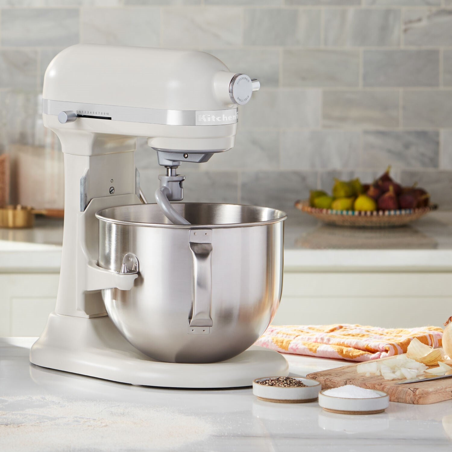 Cream stand mixer with stainless steel bowl and dough hook attachment
