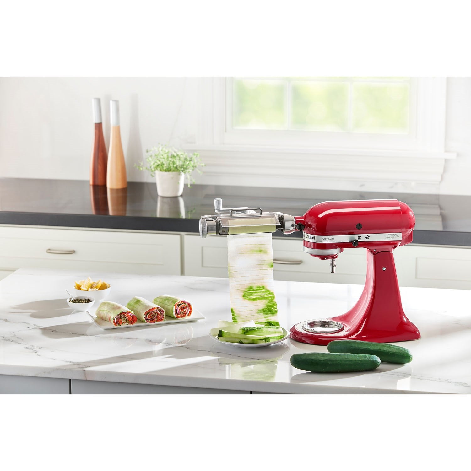 Vegetable sheet cutter attachment on red stand mixer with sliced veggie ribbons