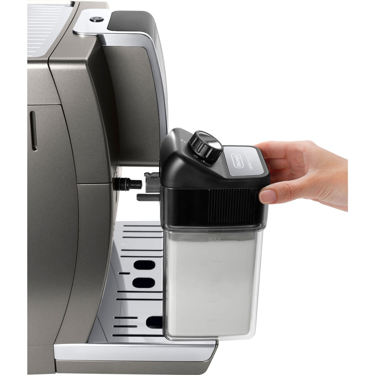 Hand inserting a milk frothing container into a titanium De'Longhi super-automatic machine