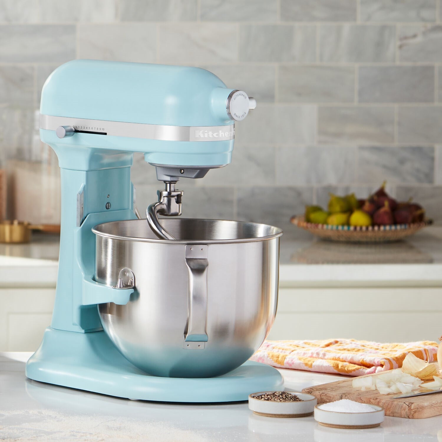 KitchenAid aqua stand mixer with stainless bowl on kitchen counter
