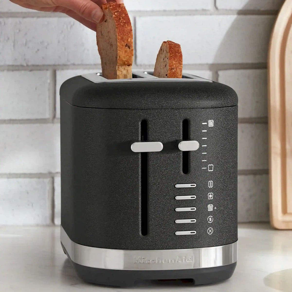 Black 2-slice toaster with two wide slots, front lever, and right-side controls