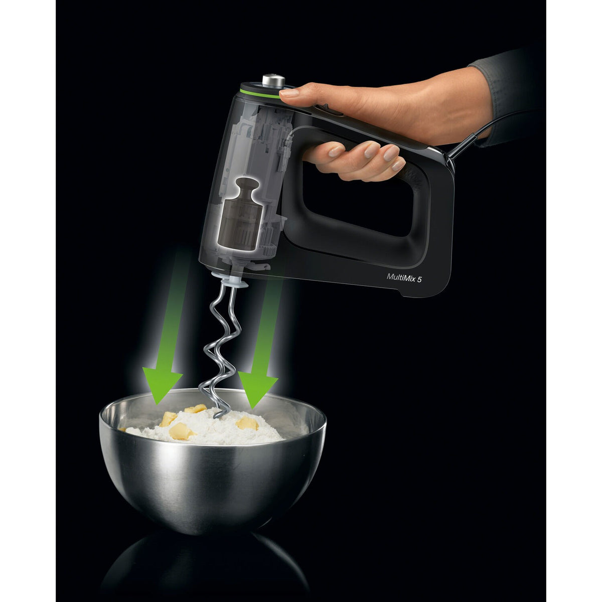 Black hand mixer beater attachment dispensing into a metal mixing bowl.