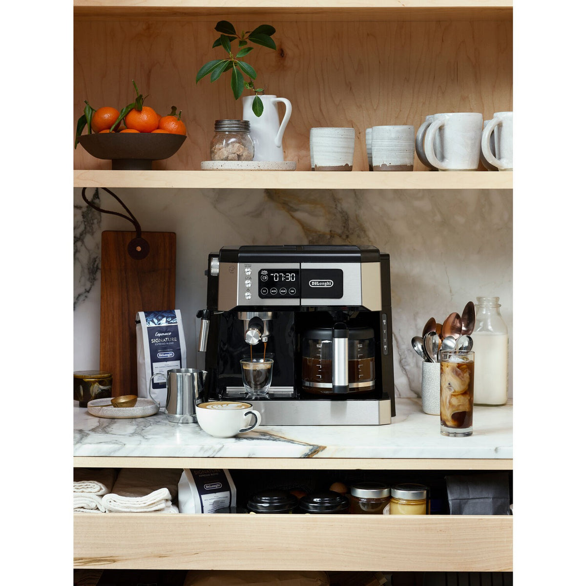 De'Longhi espresso and drip coffee machine installed in kitchen counter with carafe and mugs
