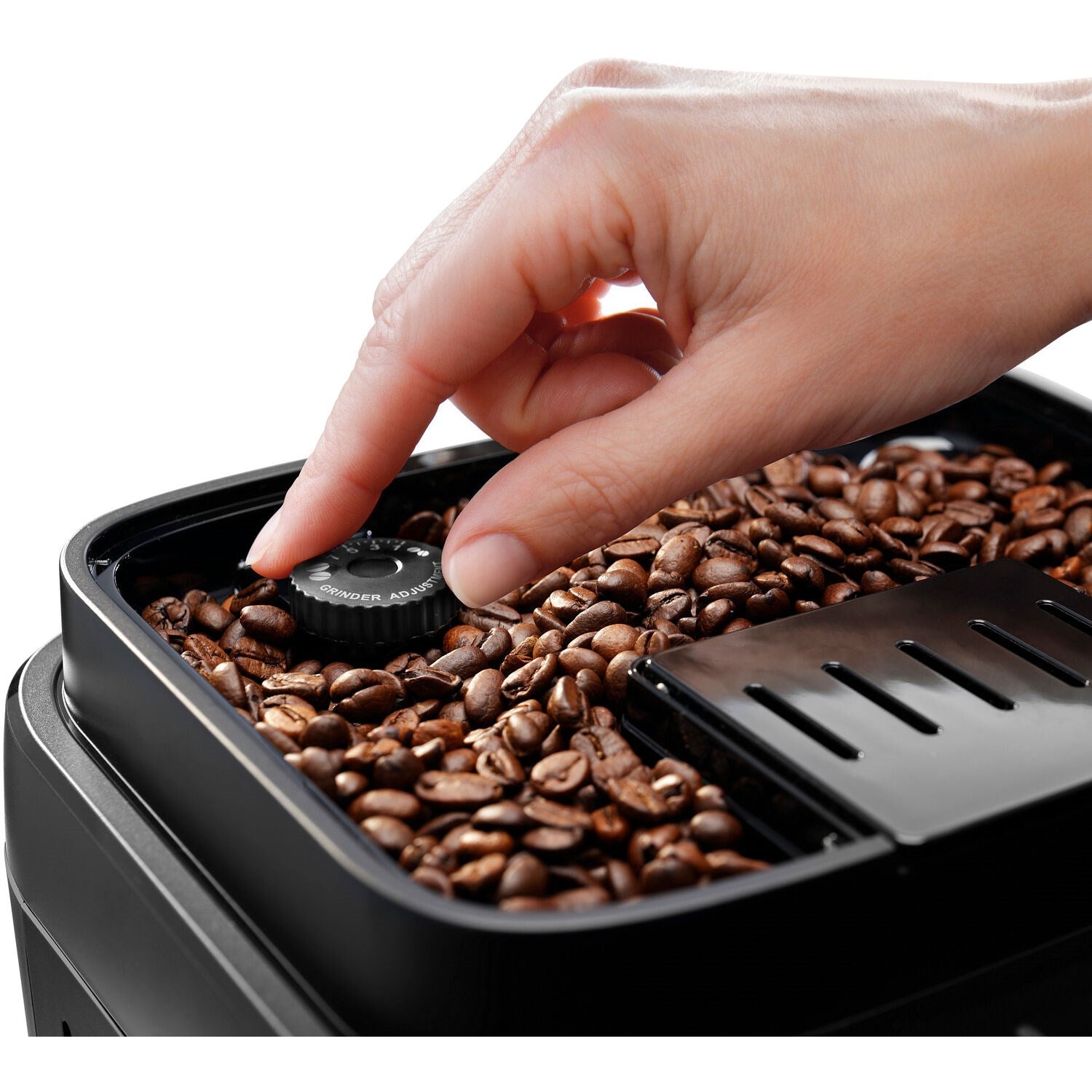 De'Longhi Magnifica Evo coffee machine bean hopper with hand and coffee beans