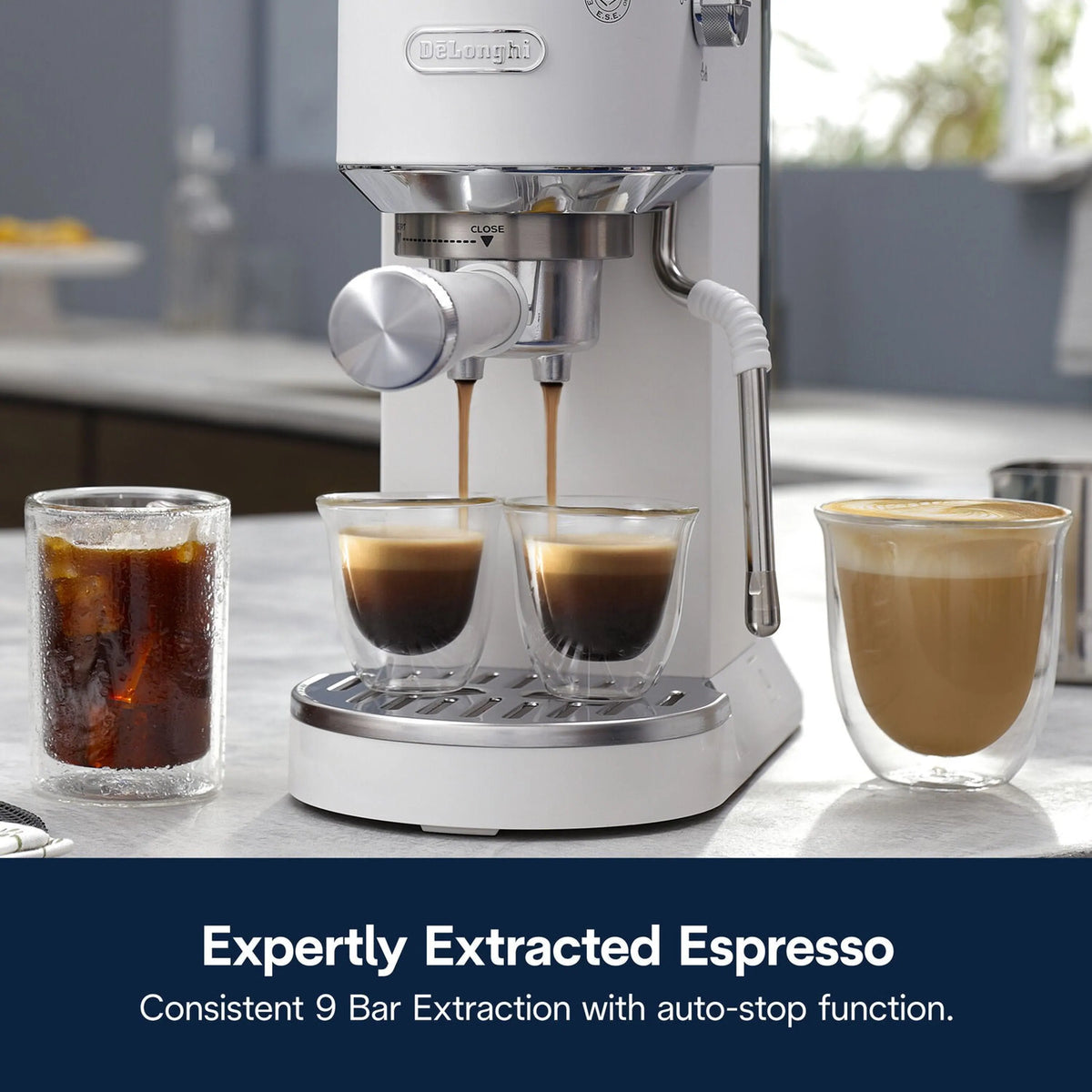 White and stainless espresso machine with frothing wand dispensing two coffee cups