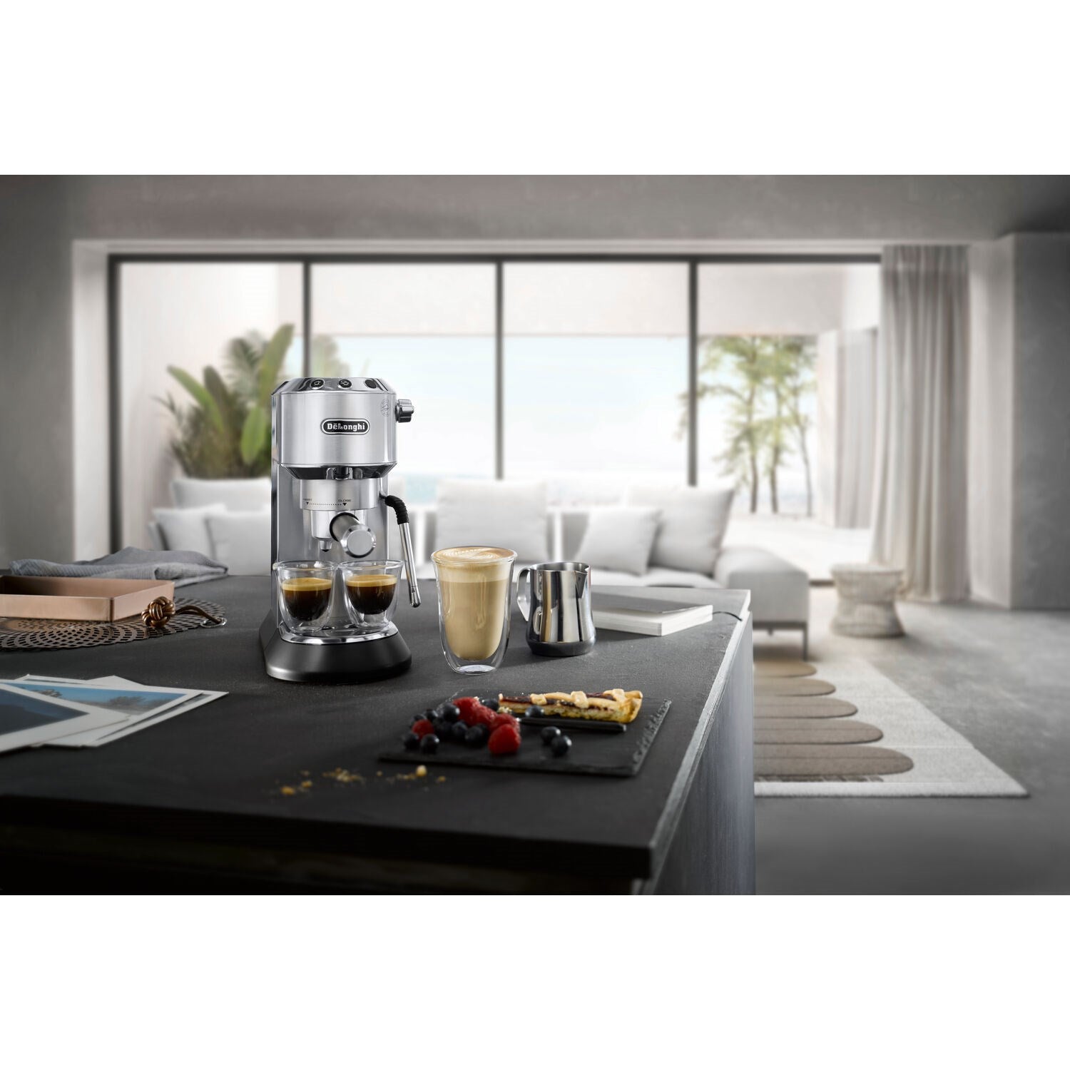 Stainless compact espresso machine with cups on a countertop
