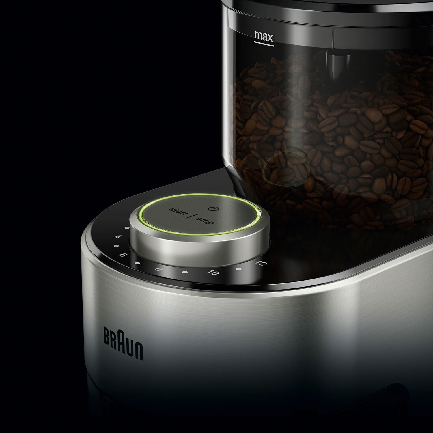 Close-up of burr coffee grinder top controls with green-lit start/stop button and beans