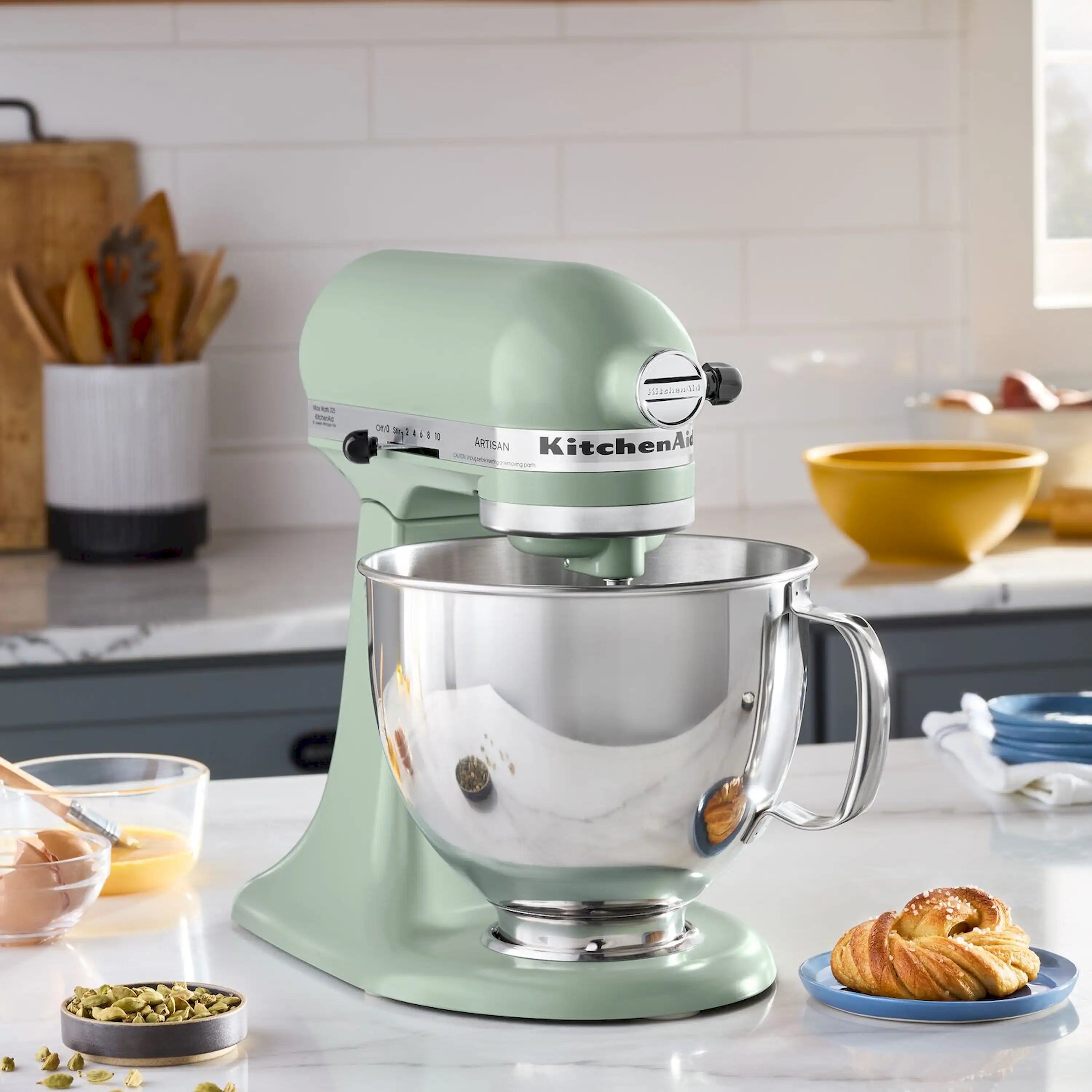 Cardamom tilt-head stand mixer with stainless bowl on kitchen counter
