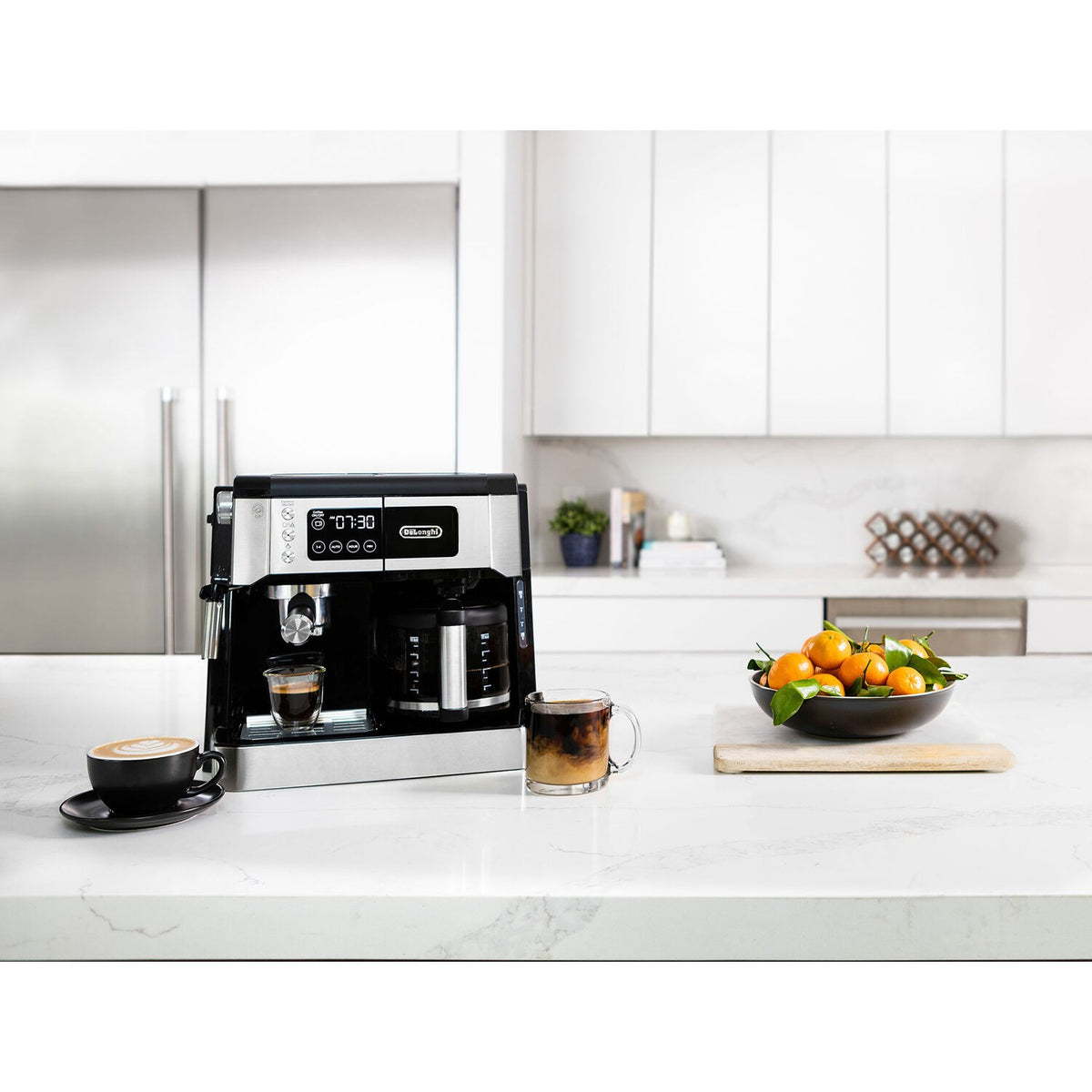 Compact De'Longhi espresso and drip machine with steam wand and cup on marble counter