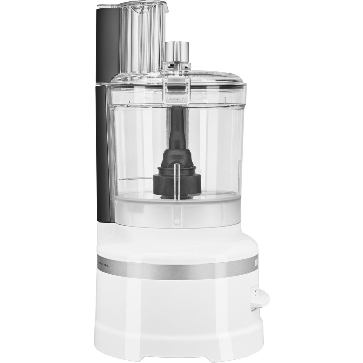 KitchenAid food processor close-up with clear bowl, black spindle, and white base