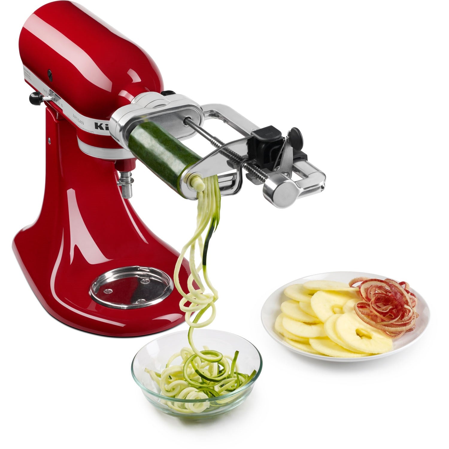 Spiralizer attachment on red stand mixer with vegetable ribbons and sliced rounds