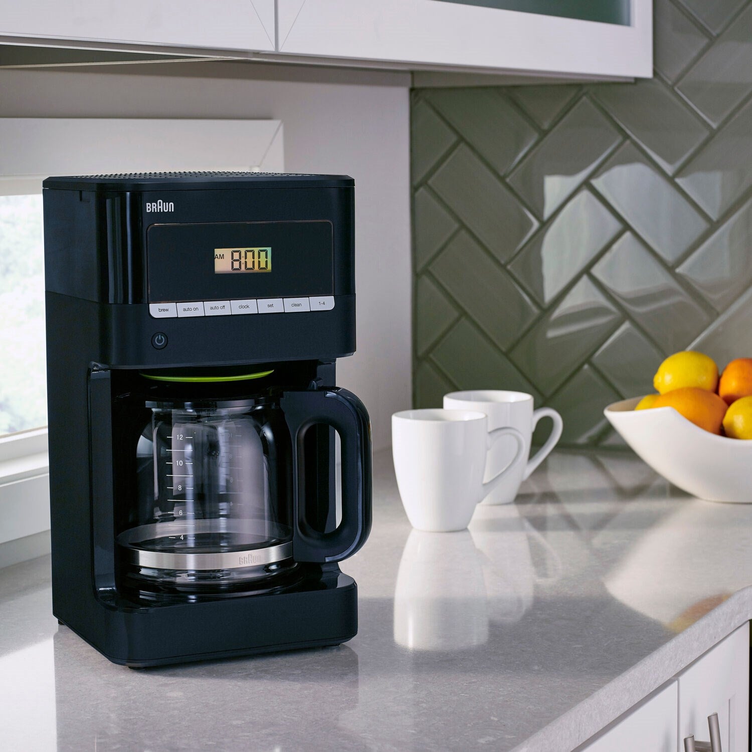 Black Braun 12-cup drip coffee maker on kitchen counter with handle and glass carafe