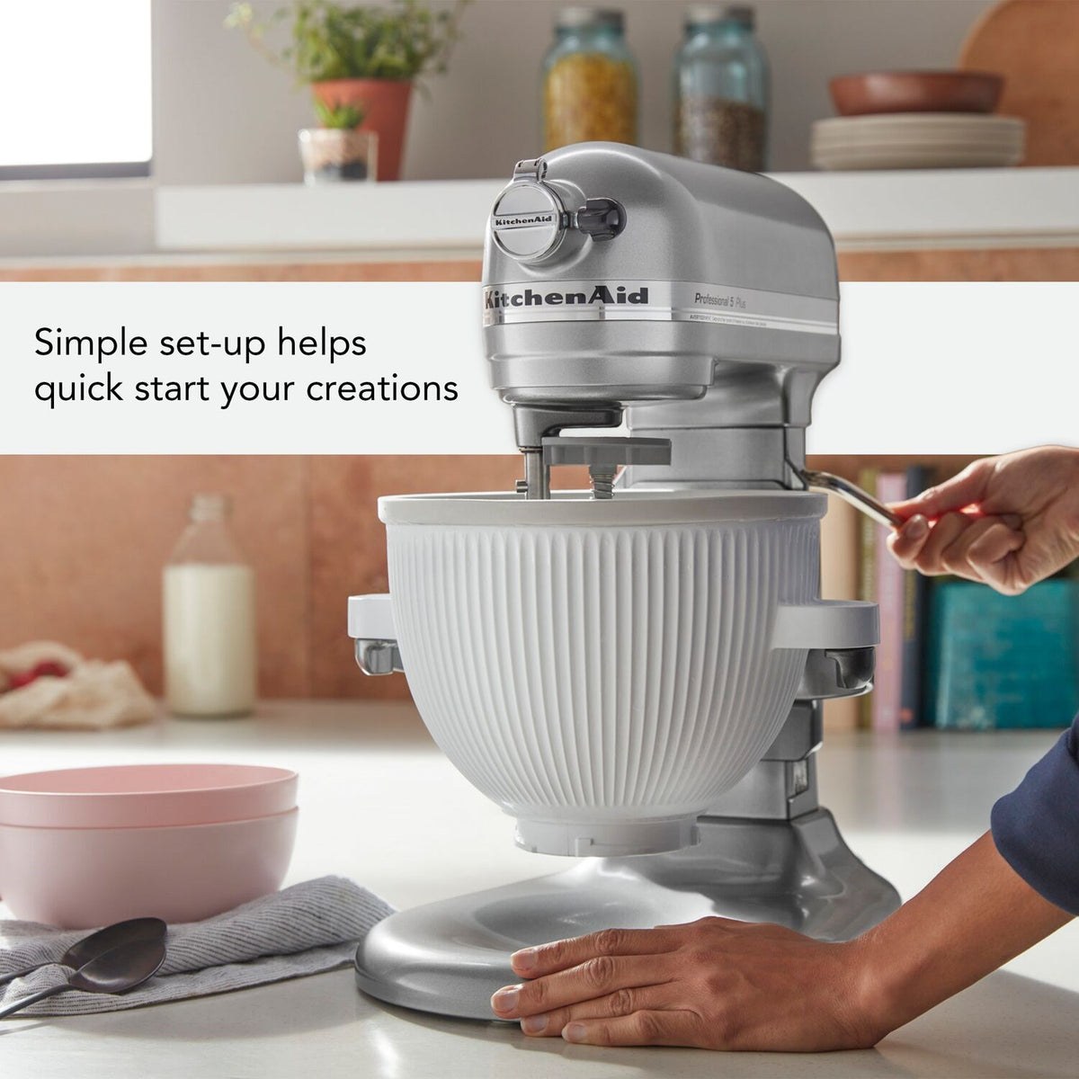 White KitchenAid ice cream maker attachment with ribbed mixing bowl and lid