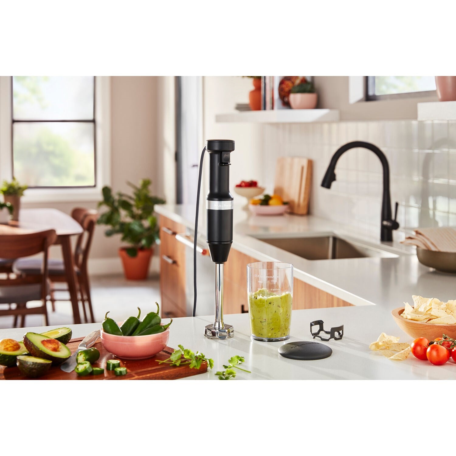 KitchenAid immersion blender blending green puree in clear jar with lid