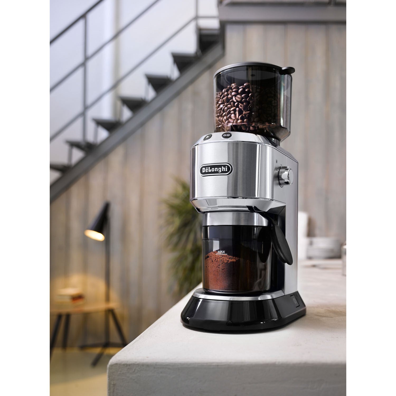 De'Longhi Dedica coffee grinder with clear hopper and visible coffee beans, countertop view