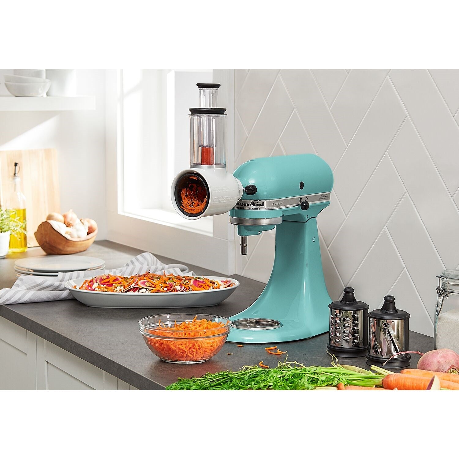 Blue aqua tilt-head stand mixer on countertop with mixing tools and prep ingredients nearby
