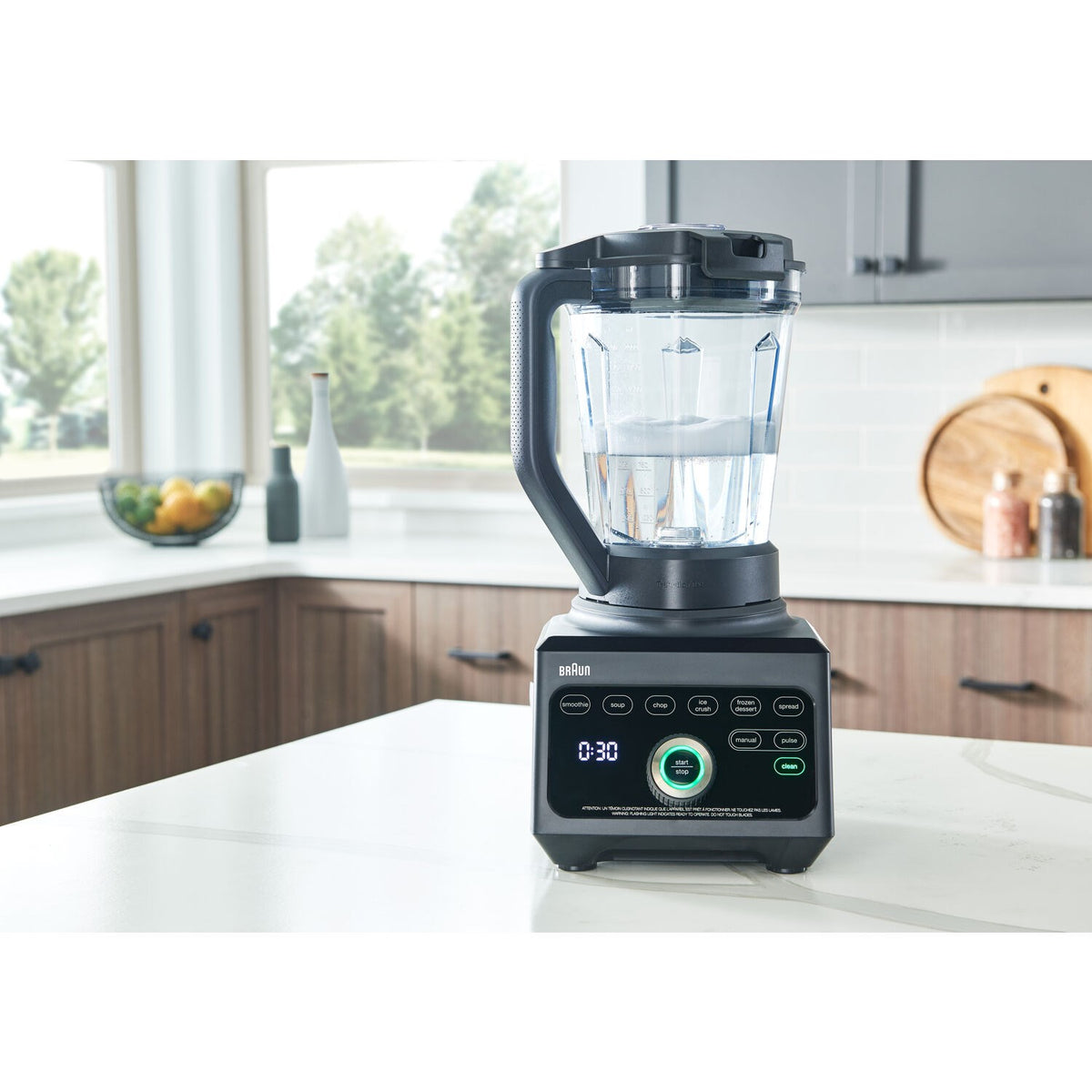Black Braun blender on countertop with clear jar and lit control screen