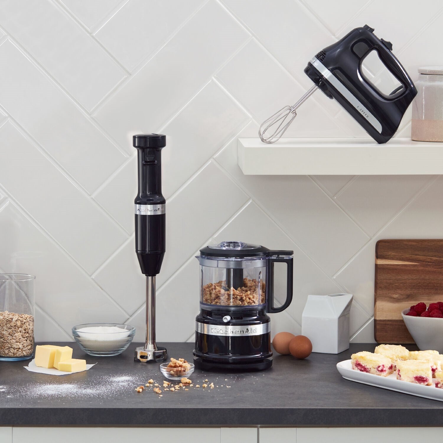 KitchenAid onyx black immersion blender with blending jar and lid on countertop