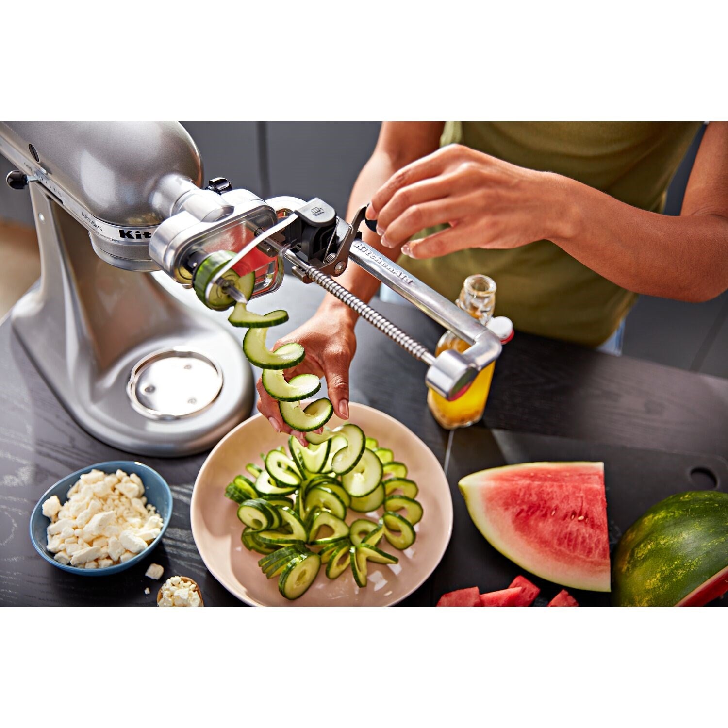 Spiralizer attachment mounted on stand mixer, with vegetables spiral-sliced