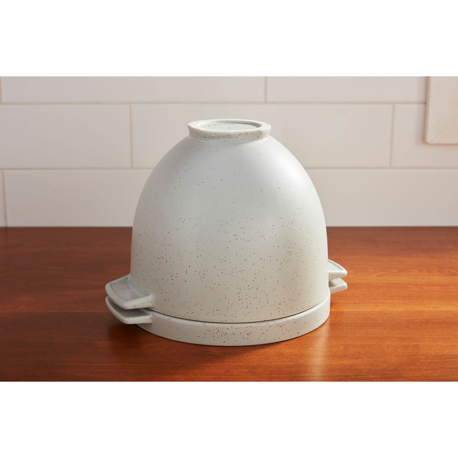 Bread baking bowl with lid, light speckled ceramic, standing on a countertop