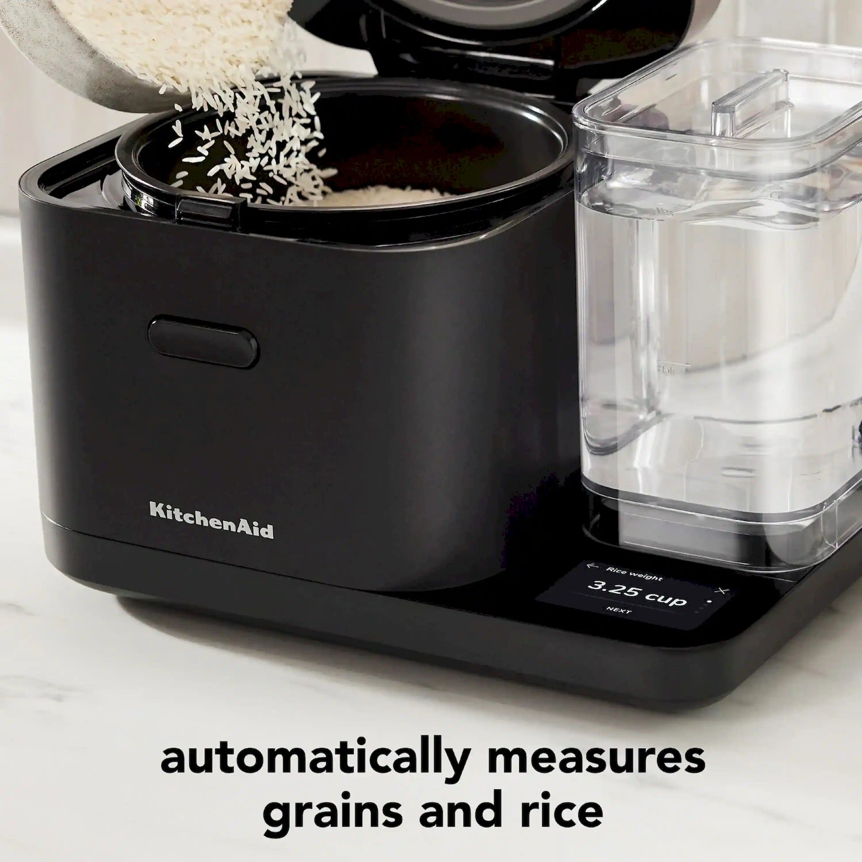 KitchenAid rice cooker close-up with open black inner pot and clear measuring tank