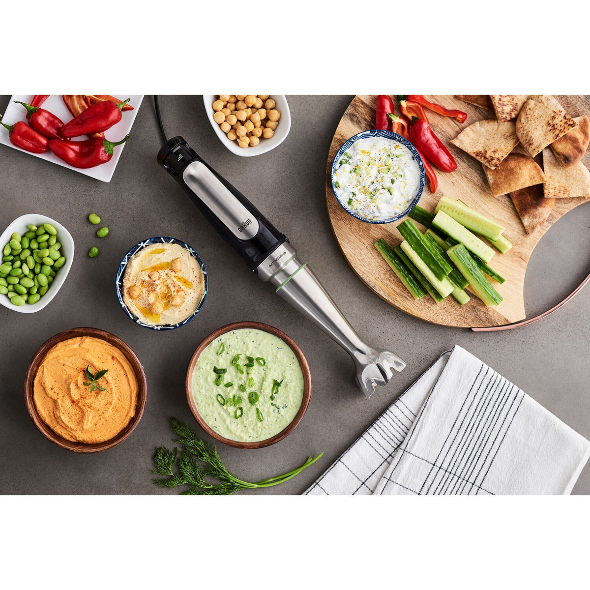 Braun hand blender over bowls with vegetable dips and spreads
