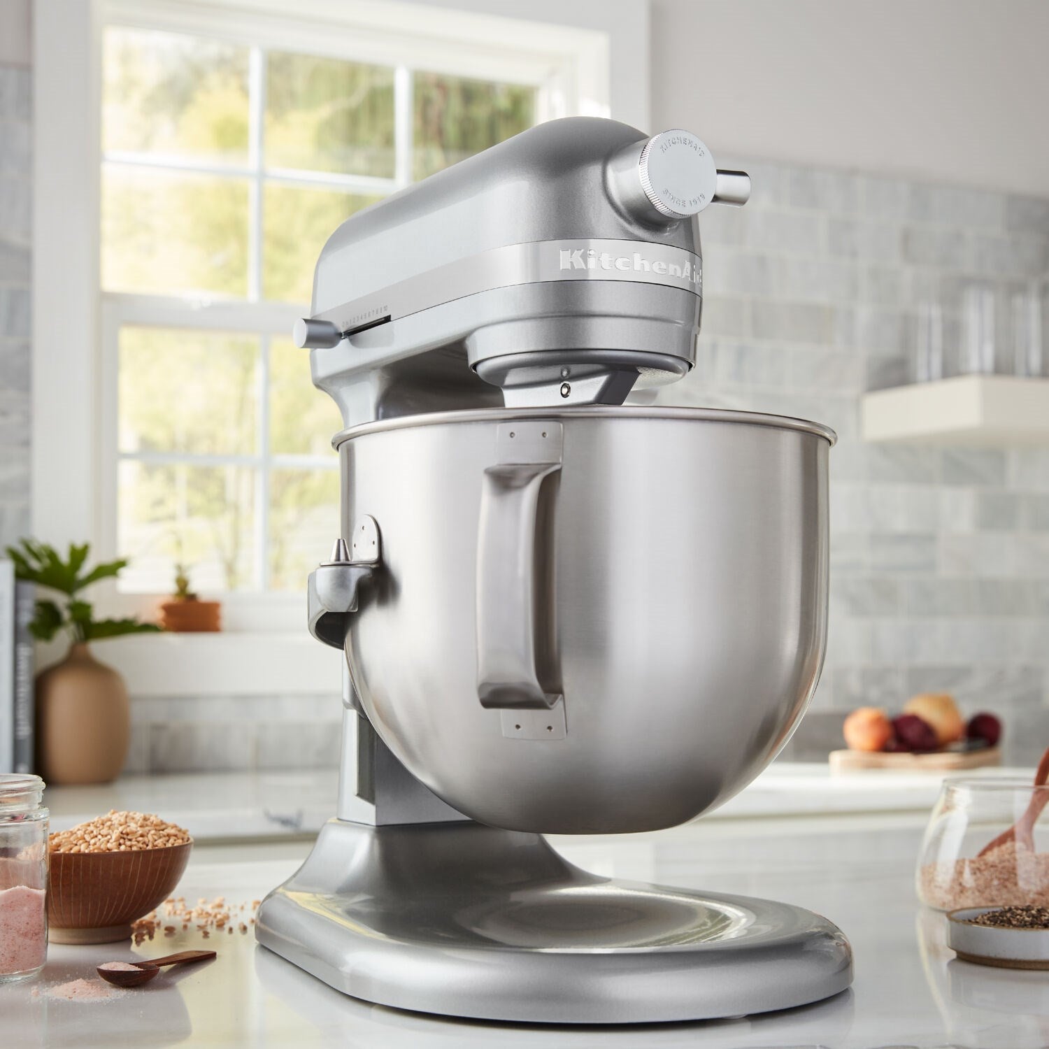 KitchenAid stand mixer with 7-quart bowl and dough hook, Contour Silver, in kitchen