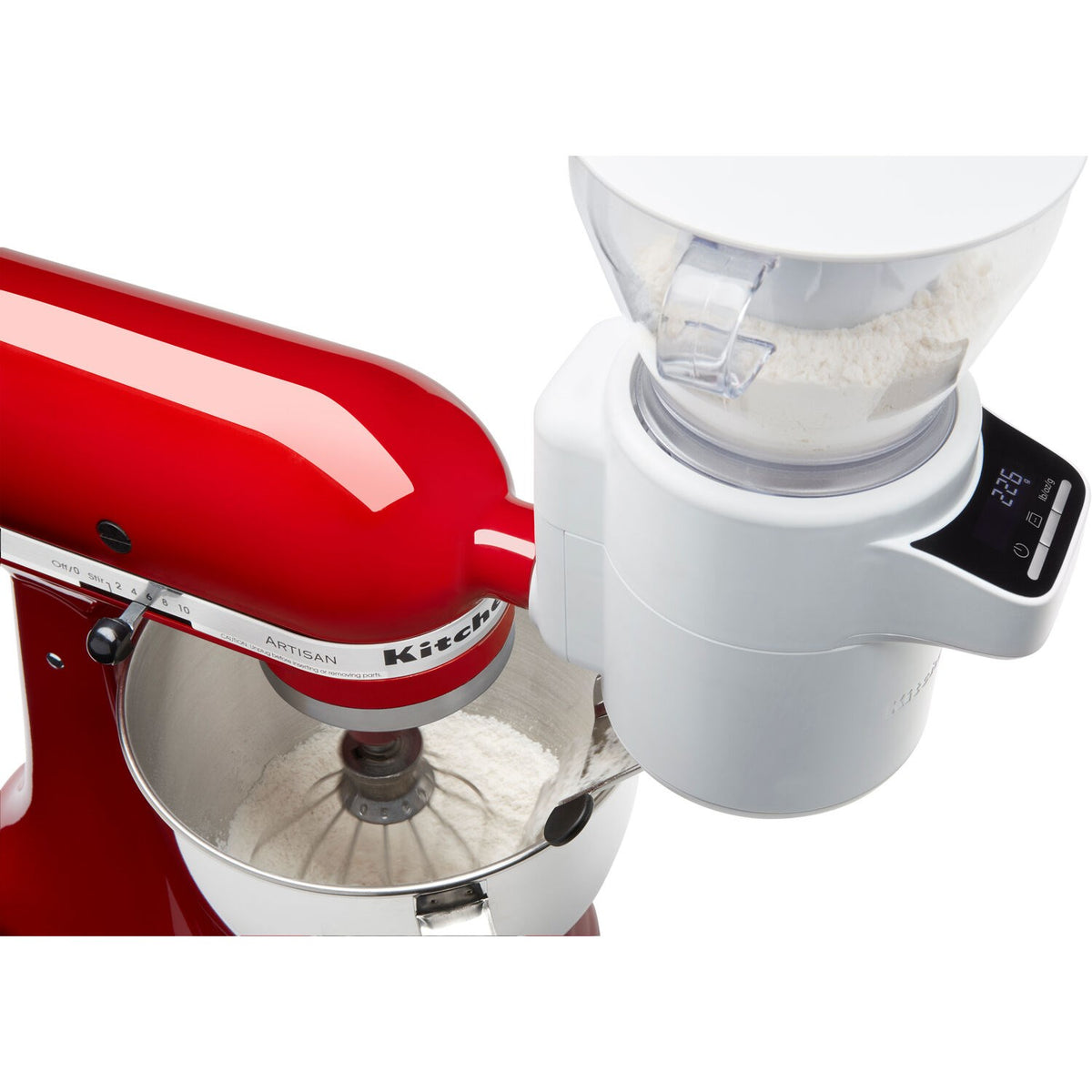 Mixer-mounted sifter and scale attachment dispensing flour into the clear chute