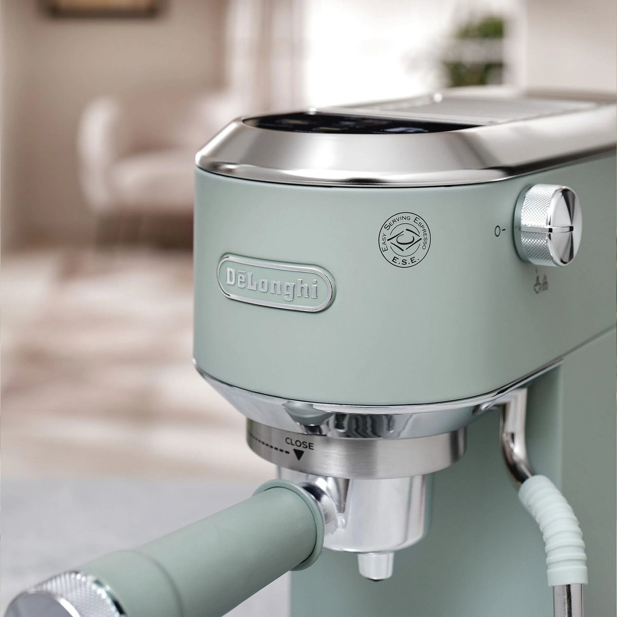 De'Longhi Dedica Duo espresso machine side view, mint green, frothing wand and control dial