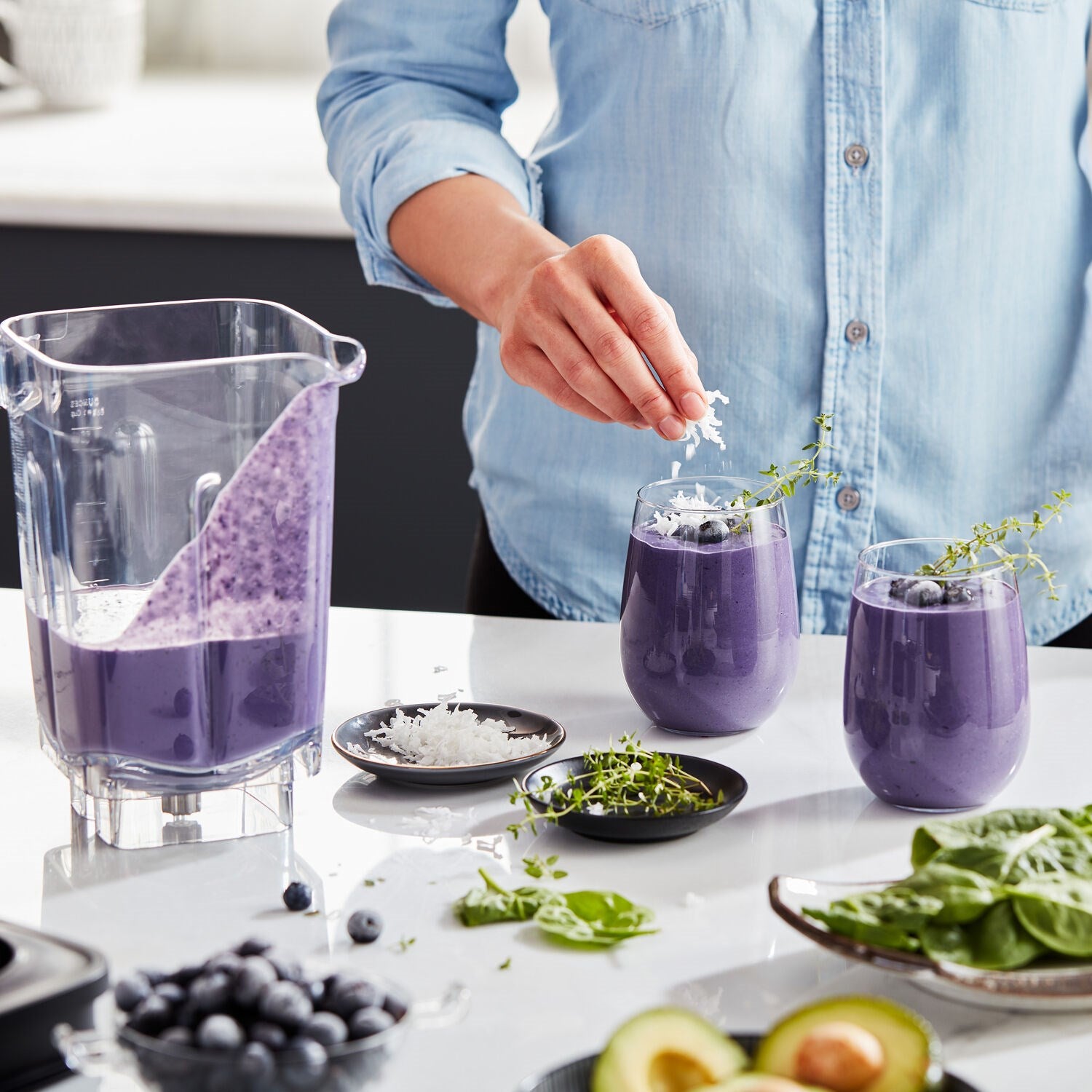 KitchenAid K400 blender purple smoothie in cups beside a clear blender jar