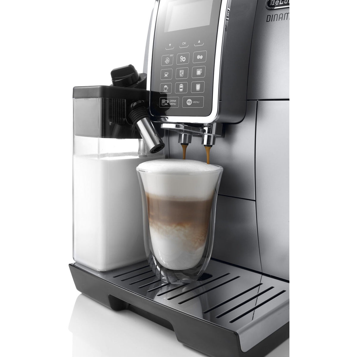 Silver machine filling a latte-style cup with froth from the spout