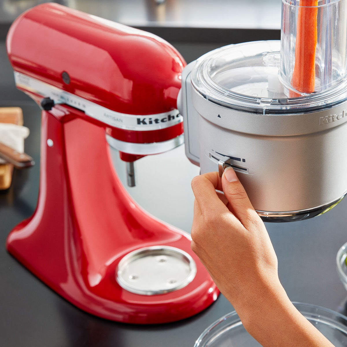Dicing attachment on mixer: clear top with feed tube and hand inserting food