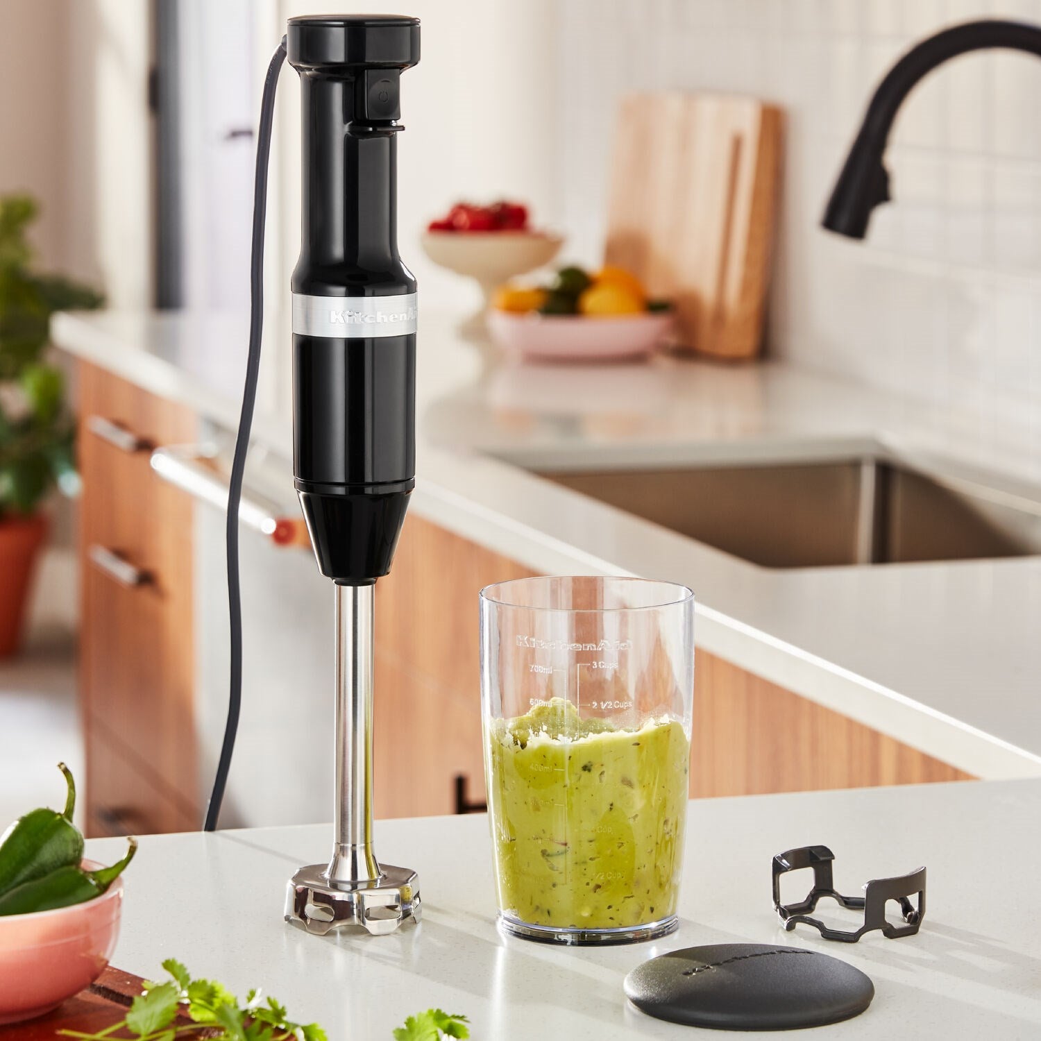 Onyx black immersion blender on counter with blending cup