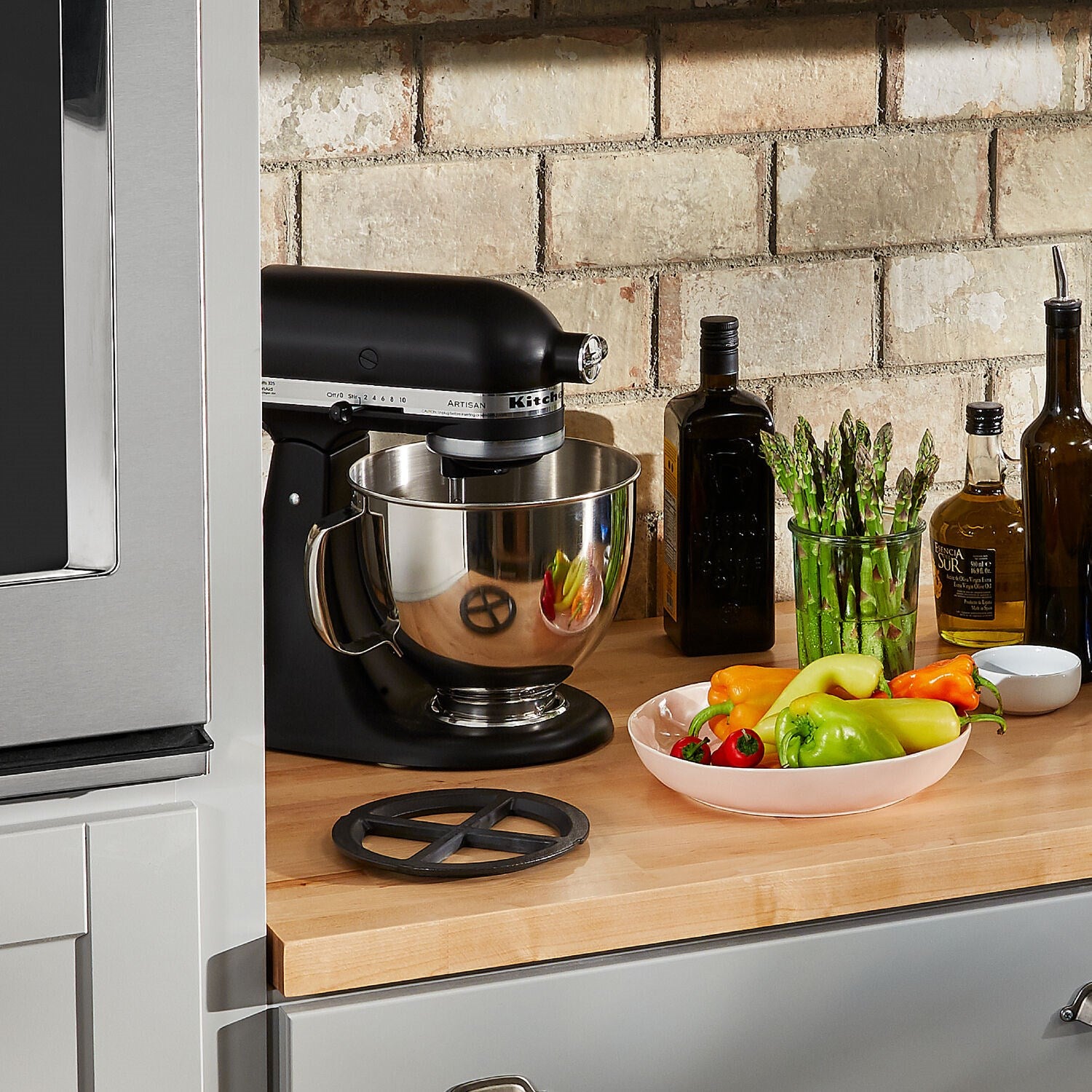 Onyx black tilt-head stand mixer with stainless bowl on countertop