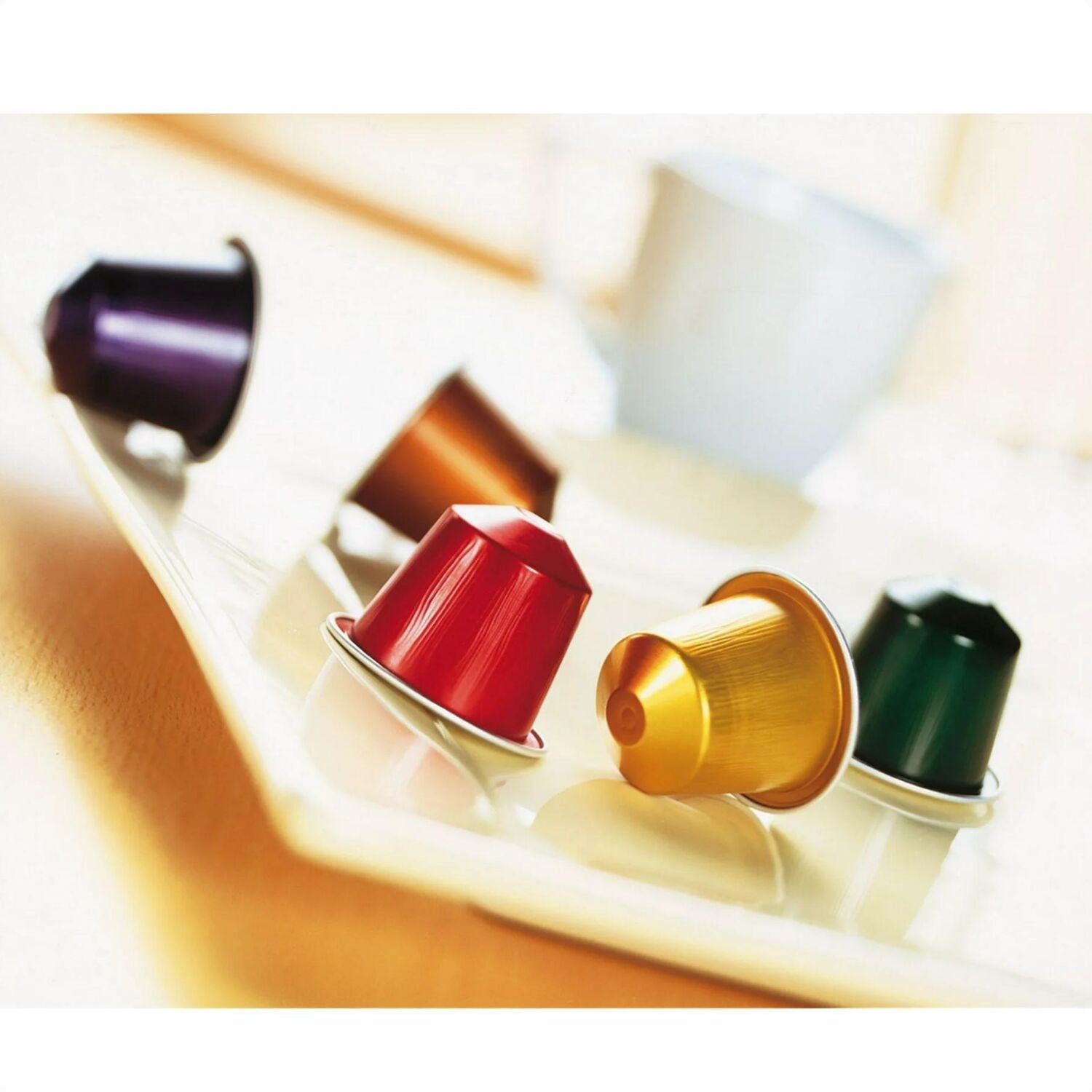 Nespresso single-serve espresso capsules in red, gold, and dark green