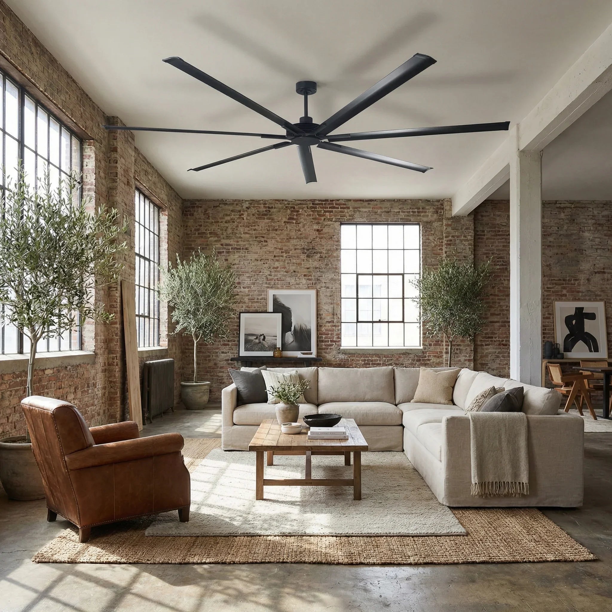 Large ceiling fan with seven blades and central motor housing in a room